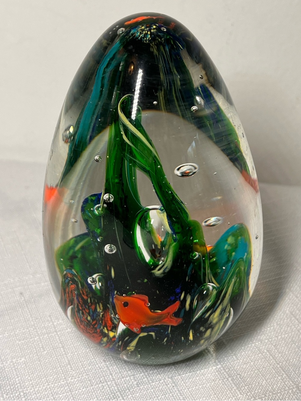Art Glass Paperweight with Green Swirls and Orange Fish
Like new